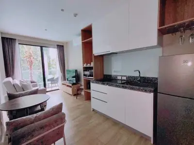 a kitchen with a counter and a table in a room at 1 Bedroom Pool view at Diamond Condo, Bangtao in Bang Tao Beach