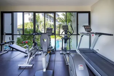 a gym with two treadmills and two ellipticals at 1 Bedroom Pool view at Diamond Condo, Bangtao in Bang Tao Beach