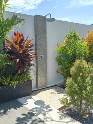 a shower in the side of a wall with plants at Bangtao Luxury Pool Villa - Prymana in Phuket Town