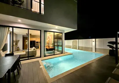 a large swimming pool in the middle of a house at Bangtao Luxury Pool Villa - Prymana in Phuket Town