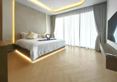 a bedroom with a bed and a large window at Bangtao Luxury Pool Villa - Prymana in Phuket Town