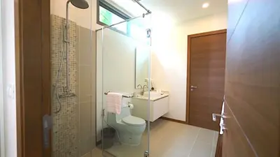 a bathroom with a toilet and a sink and a shower at 4 Bedrooms Private Pool Villa near Rawai Beach in Rawai Beach