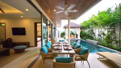 a dining room with a table and chairs and a pool at 4 Bedrooms Private Pool Villa near Rawai Beach in Rawai Beach