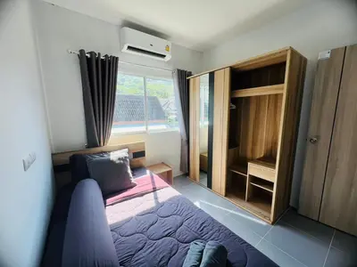 a small bedroom with a bed and a window at Arin Townhome @Bangtao in Ban Thalat Choeng Thale
