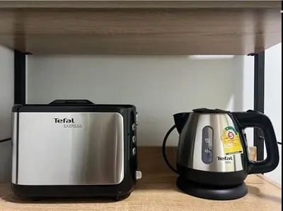 a microwave and a toaster sitting on a counter at Arin Townhome @Bangtao in Ban Thalat Choeng Thale