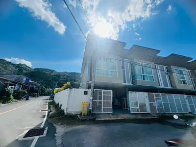 a house with the sun shining on the side of it at Arin Townhome @Bangtao in Ban Thalat Choeng Thale