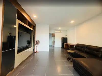 a living room with a couch and a flat screen tv at Arin Townhome @Bangtao in Ban Thalat Choeng Thale