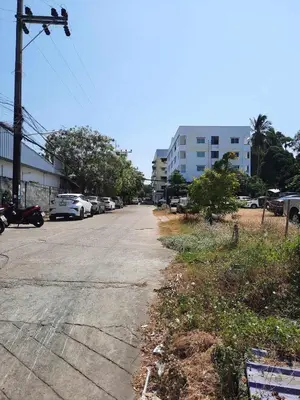 an empty street with cars parked on the side of the road at Apartment in Rawai in Rawai Beach
