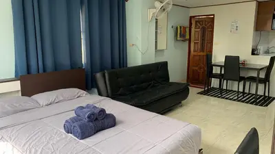 a bedroom with a bed with purple towels on it at Apartment in Rawai in Rawai Beach