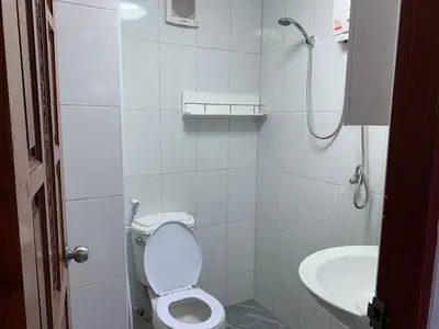 a white bathroom with a toilet and a sink at Apartment in Rawai in Rawai Beach