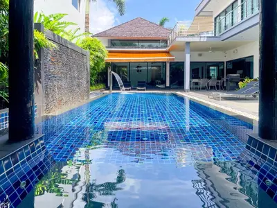 a swimming pool in front of a house at Tropical Haven 4 Bedroom Pool Villa in Bang Tao Beach