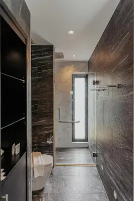a bathroom with a toilet and a glass shower at Tropical Haven 4 Bedroom Pool Villa in Bang Tao Beach