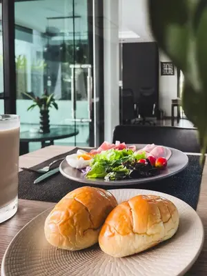 two plates of food on a table with a sandwich and salad at Tropical Haven 4 Bedroom Pool Villa in Bang Tao Beach