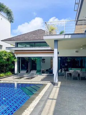 a house with a swimming pool next to a house at Tropical Haven 4 Bedroom Pool Villa in Bang Tao Beach