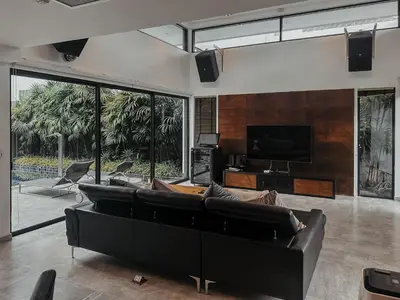 a living room with a couch and a tv at Tropical Haven 4 Bedroom Pool Villa in Bang Tao Beach