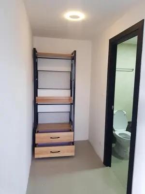 a bathroom with a toilet and a mirror at Rawai beach condominium Phuket in Nai Harn Beach