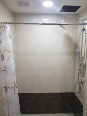 a shower in a bathroom with a shower curtain at Rawai beach condominium Phuket in Nai Harn Beach