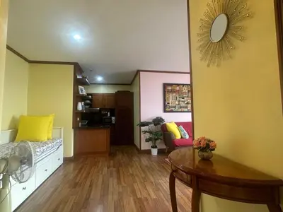 a living room with a table and yellow walls at PATONG TOWER SEA FACING HIGH FLOOR New Bathroom in Patong Beach