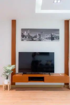 a living room with a large flat screen tv at Patong Kalim Unparalleled Sea View B&B Resort in Patong Beach