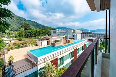 a view from the balcony of a building with a swimming pool at Patong Kalim Unparalleled Sea View B&B Resort in Patong Beach