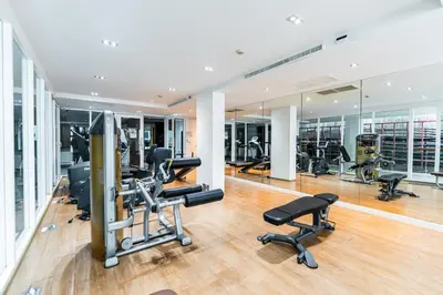 a gym with treadmills and cardio equipment in a building at Patong Kalim Unparalleled Sea View B&B Resort in Patong Beach
