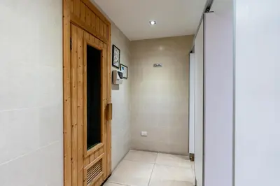 a hallway with a wooden door in a room at Patong Kalim Unparalleled Sea View B&B Resort in Patong Beach
