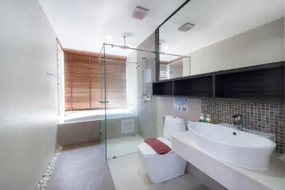 a bathroom with a sink and a toilet and a shower at Patong Kalim Unparalleled Sea View B&B Resort in Patong Beach