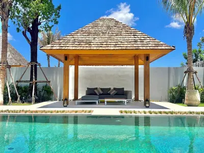 a gazebo next to a swimming pool at New luxury villa with maid Anchan Tropicana in Bang Tao Beach