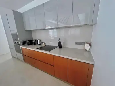 a kitchen with white cabinets and a sink at New luxury villa with maid Anchan Tropicana in Bang Tao Beach