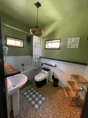 a bathroom with a sink and a toilet and a tub at Aisawan Resort villa in Surin Beach