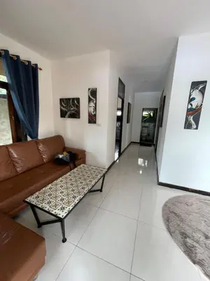 a living room with a couch and a coffee table at Aisawan Resort villa in Surin Beach