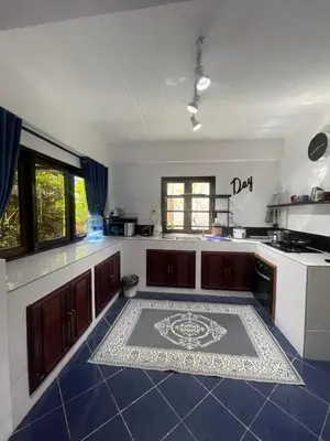 a kitchen with a rug on the floor at Aisawan Resort villa in Surin Beach