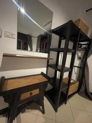 a room with a mirror and a table and a shelf at Aisawan Resort villa in Surin Beach