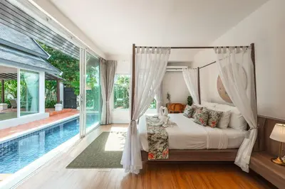 a bedroom with a bed and a swimming pool at Rosemary Villa 4 bedrooms with Pool near BangTao Beach in Bang Tao Beach