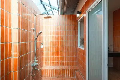 a bathroom with a shower with orange tiles at Rosemary Villa 4 bedrooms with Pool near BangTao Beach in Bang Tao Beach