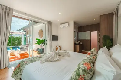 a bedroom with a white bed with a large window at Rosemary Villa 4 bedrooms with Pool near BangTao Beach in Bang Tao Beach