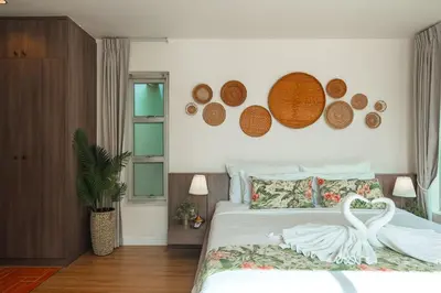 two white swans on a bed in a bedroom at Rosemary Villa 4 bedrooms with Pool near BangTao Beach in Bang Tao Beach