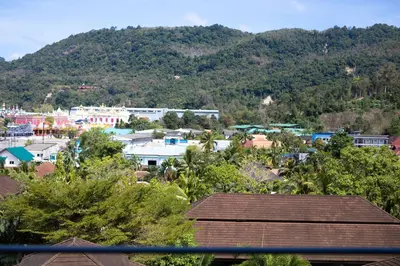 a view of a city with a mountain in the background at Tropics Kamala Hill View Suite CTG D707, near Beach and Fantasea in Kamala Beach