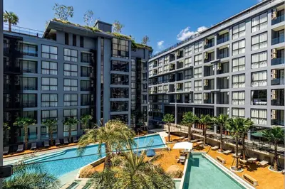 an apartment building with a pool and palm trees at Tropics Kamala Hill View Suite CTG D707, near Beach and Fantasea in Kamala Beach