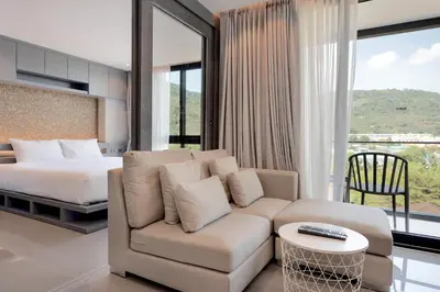 a bedroom with a couch and a bed and a bed and window at Tropics Kamala Hill View Suite CTG D707, near Beach and Fantasea in Kamala Beach