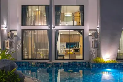 a house with a swimming pool in front of a building at Pool Access Utopia Loft, just 10 min from Nai Harn Beach, UTL A116 in Rawai Beach