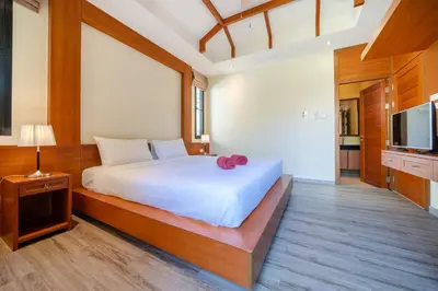 a bedroom with a white bed and a television at Private 2BR Pool Villa 2D03 in Gated Residence Rawai VIP Villas in Rawai Beach