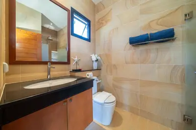a bathroom with a sink and a toilet and a mirror at Private 2BR Pool Villa 2D03 in Gated Residence Rawai VIP Villas in Rawai Beach