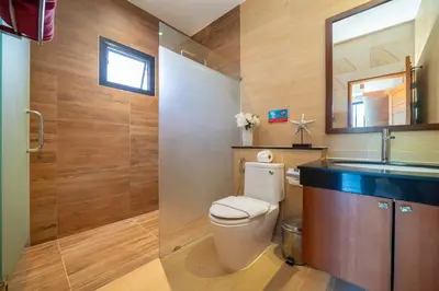 a bathroom with a toilet and a sink at Private 2BR Pool Villa 2D15 in Gated Residences Rawai VIP Villas near Kids Park in Rawai Beach