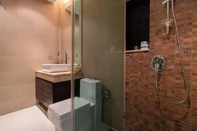 a bathroom with a shower and a toilet and a sink at 13 - Seaside Bliss Overlooking Rawai Beach in Phuket Town