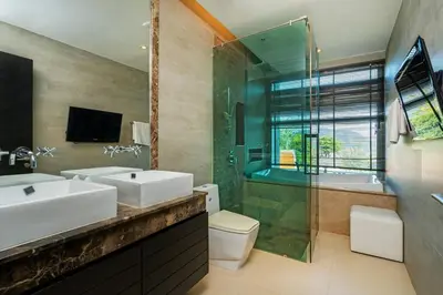 a bathroom with two sinks and a shower and a tub at 13 - Seaside Bliss Overlooking Rawai Beach in Phuket Town