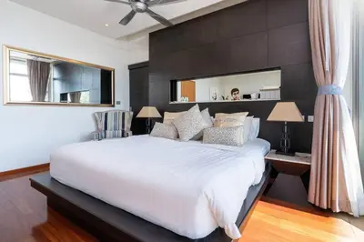 a bedroom with a large white bed and a mirror at 13 - Seaside Bliss Overlooking Rawai Beach in Phuket Town