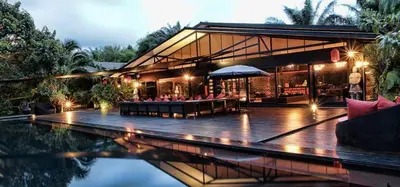 a building with a pool in front of a house at 05 - Exquisite Paradise Retreat in Nai Thon Beach