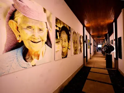a hallway with pictures of an older woman on the wall at Villa 29 Montebello Andara Resort Villas in Kamala Beach