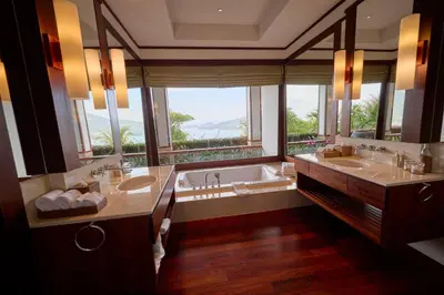 a bathroom with two sinks and a tub with a window at Villa 29 Montebello Andara Resort Villas in Kamala Beach